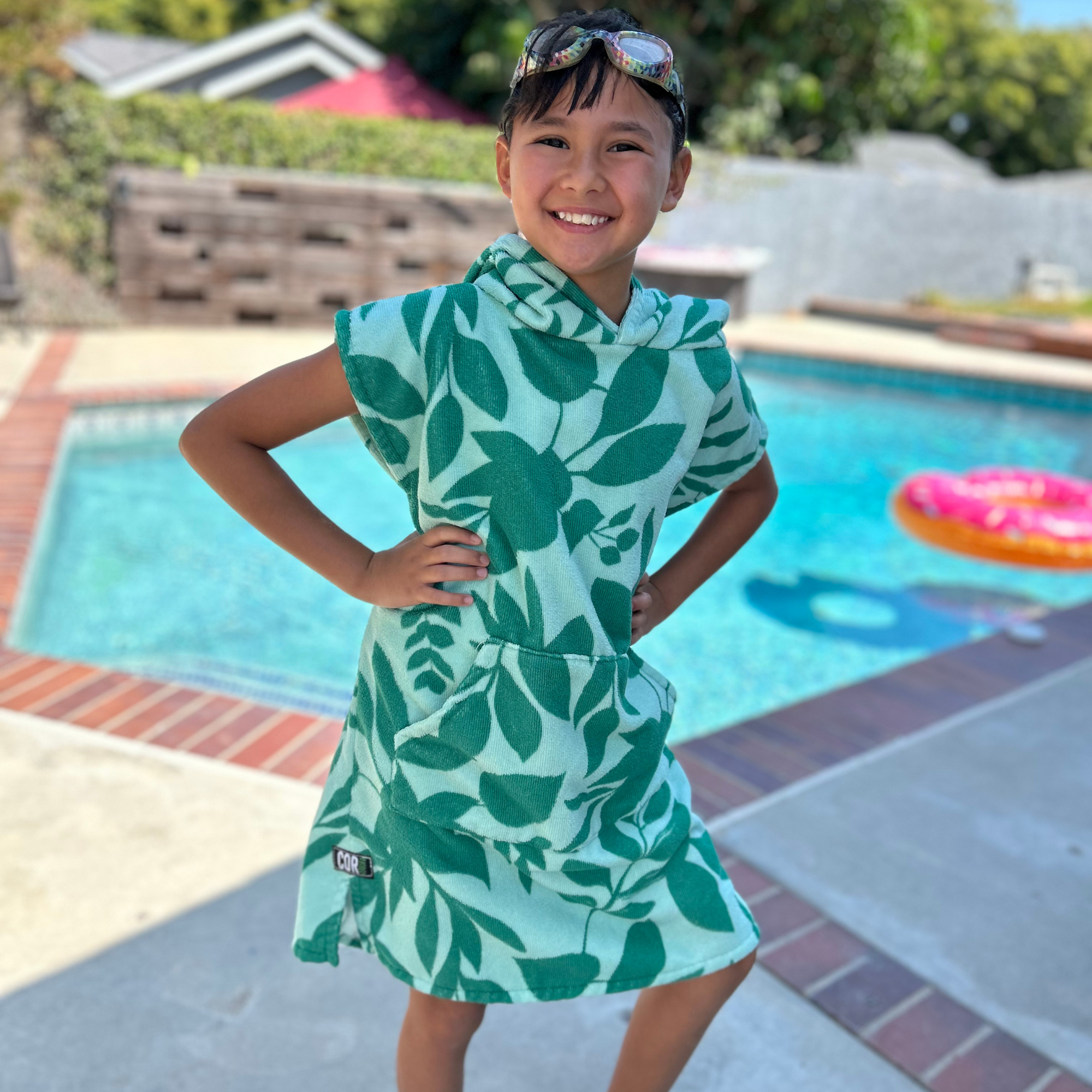 Kids' Kailua Changing Towel Poncho by COR Surf, a soft, absorbent apparel for changing and drying after swimming.