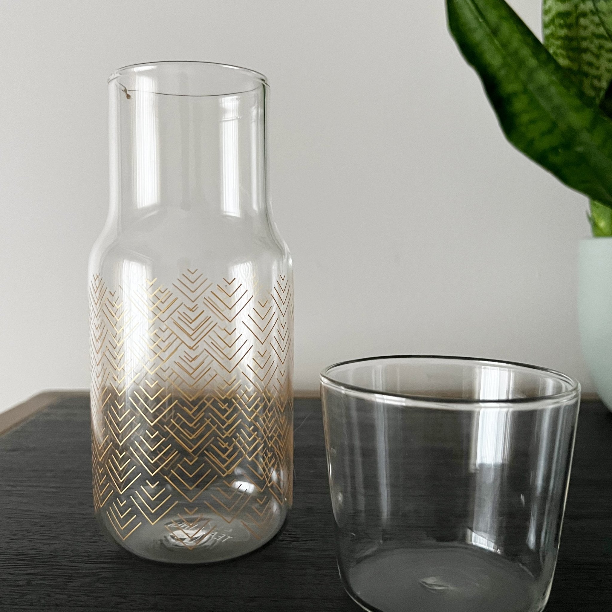 Chevron bedside carafe by Tea + Linen, featuring a stylish chevron pattern and glass material for elegant tableware.