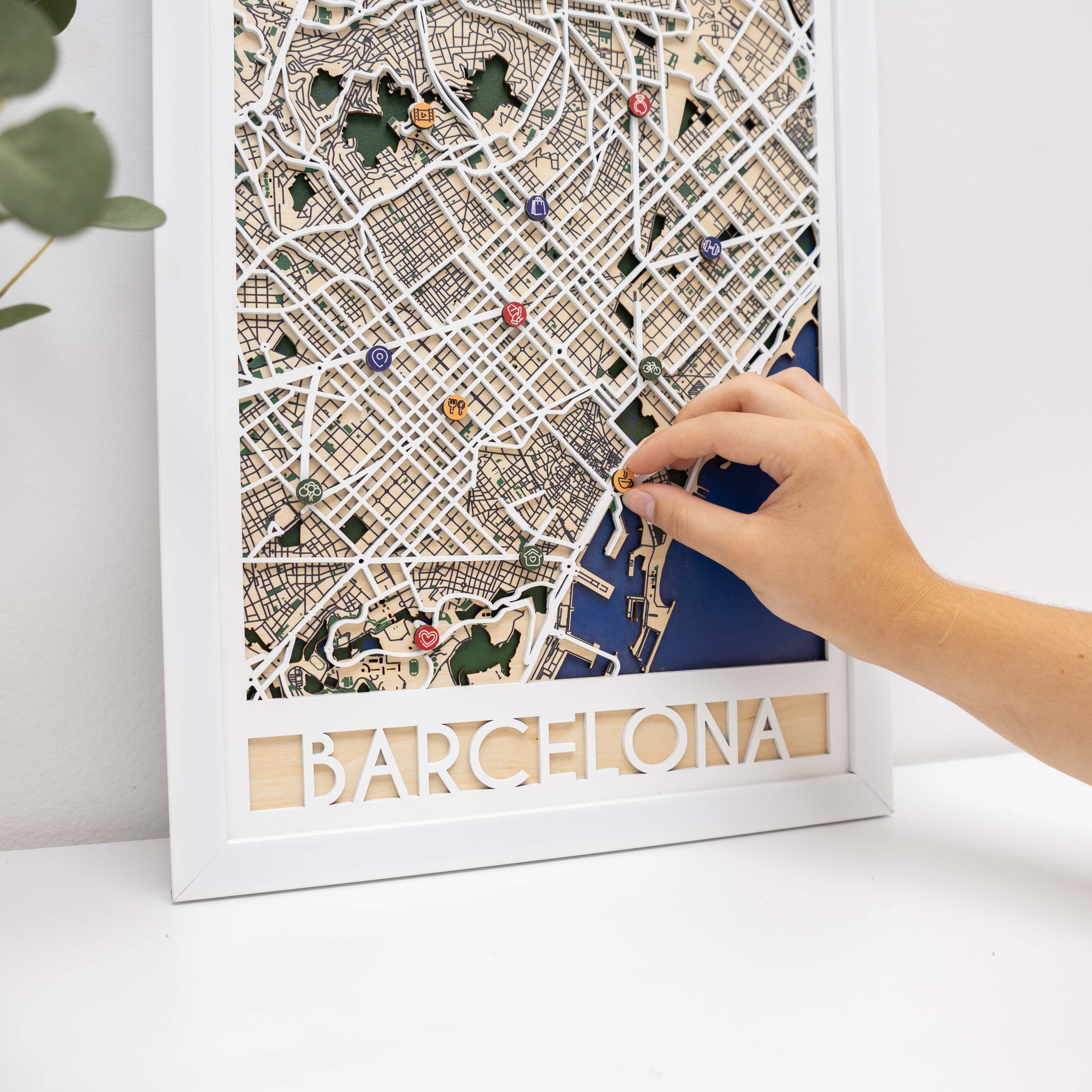 Wooden map pins from Enjoy The Wood marking special events on a Barcelona city map for lifestyle icons.