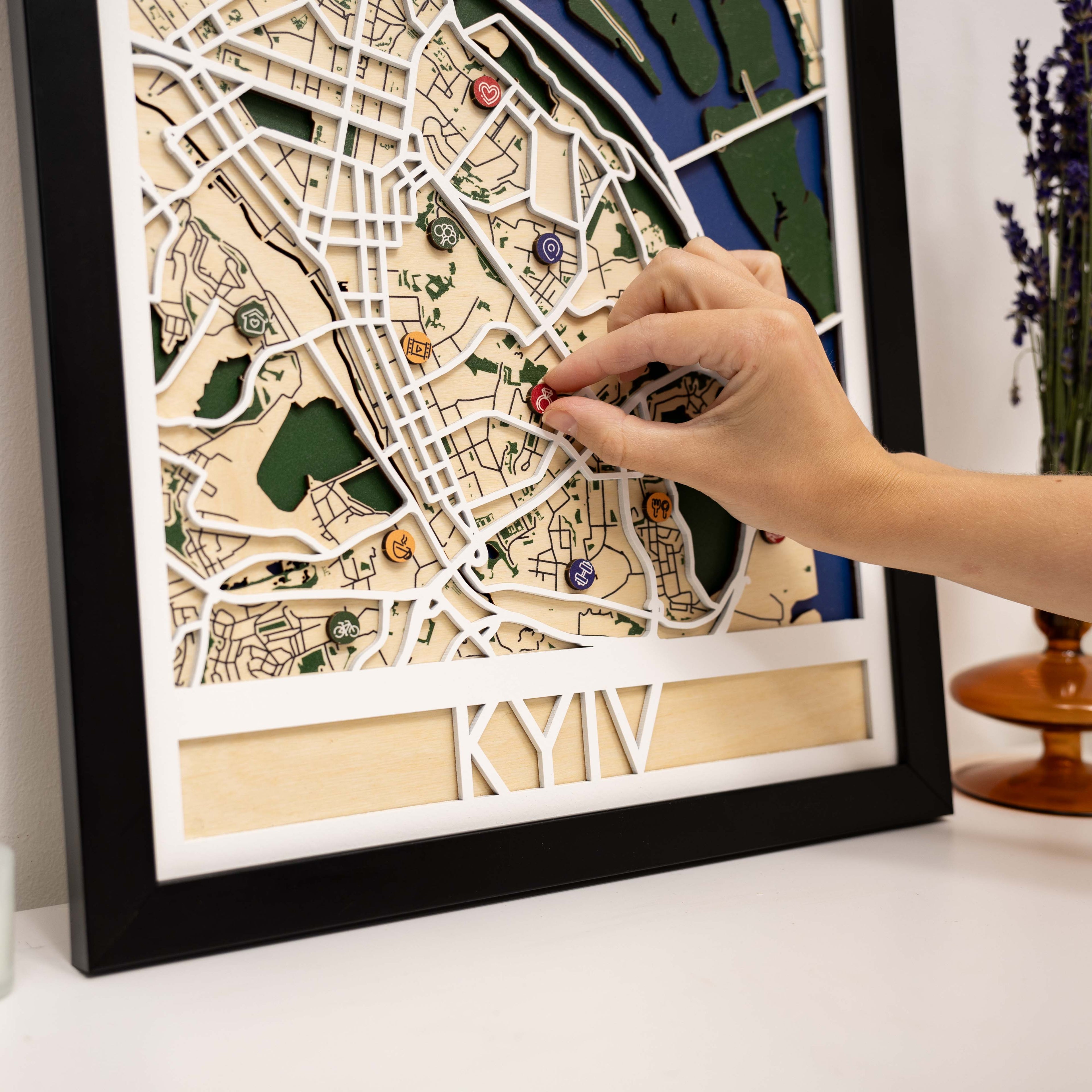 Wooden map pins from Enjoy The Wood marking Kyiv city on a lifestyle map for special events.