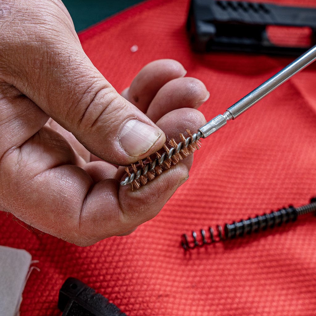 SFT2 Tactical pistol caliber cleaning kit with brushes and tools for firearm maintenance and cleaning.