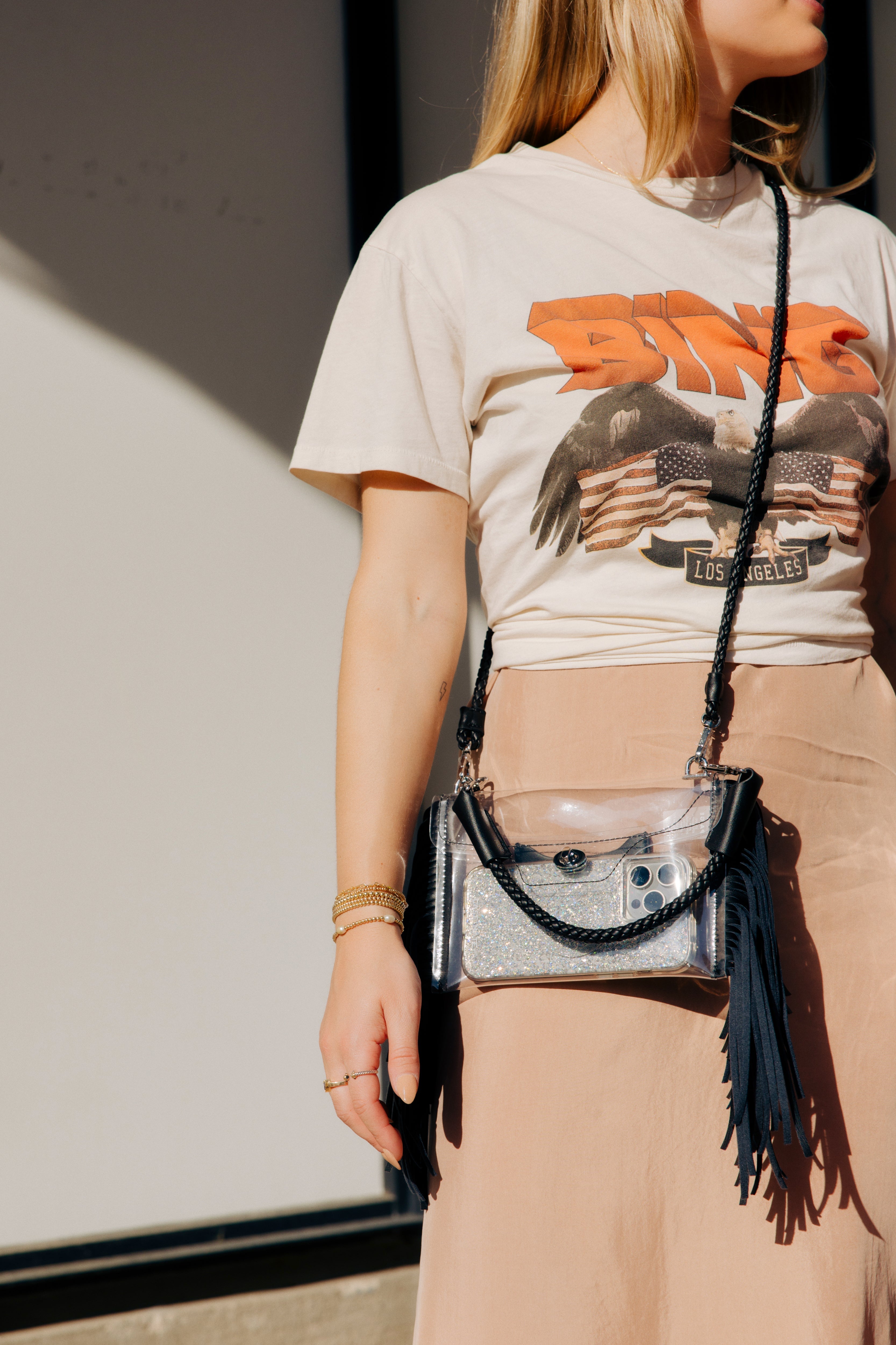 Clear fringe crossbody handbag by Margo Paige with a transparent body and decorative fringe detailing.