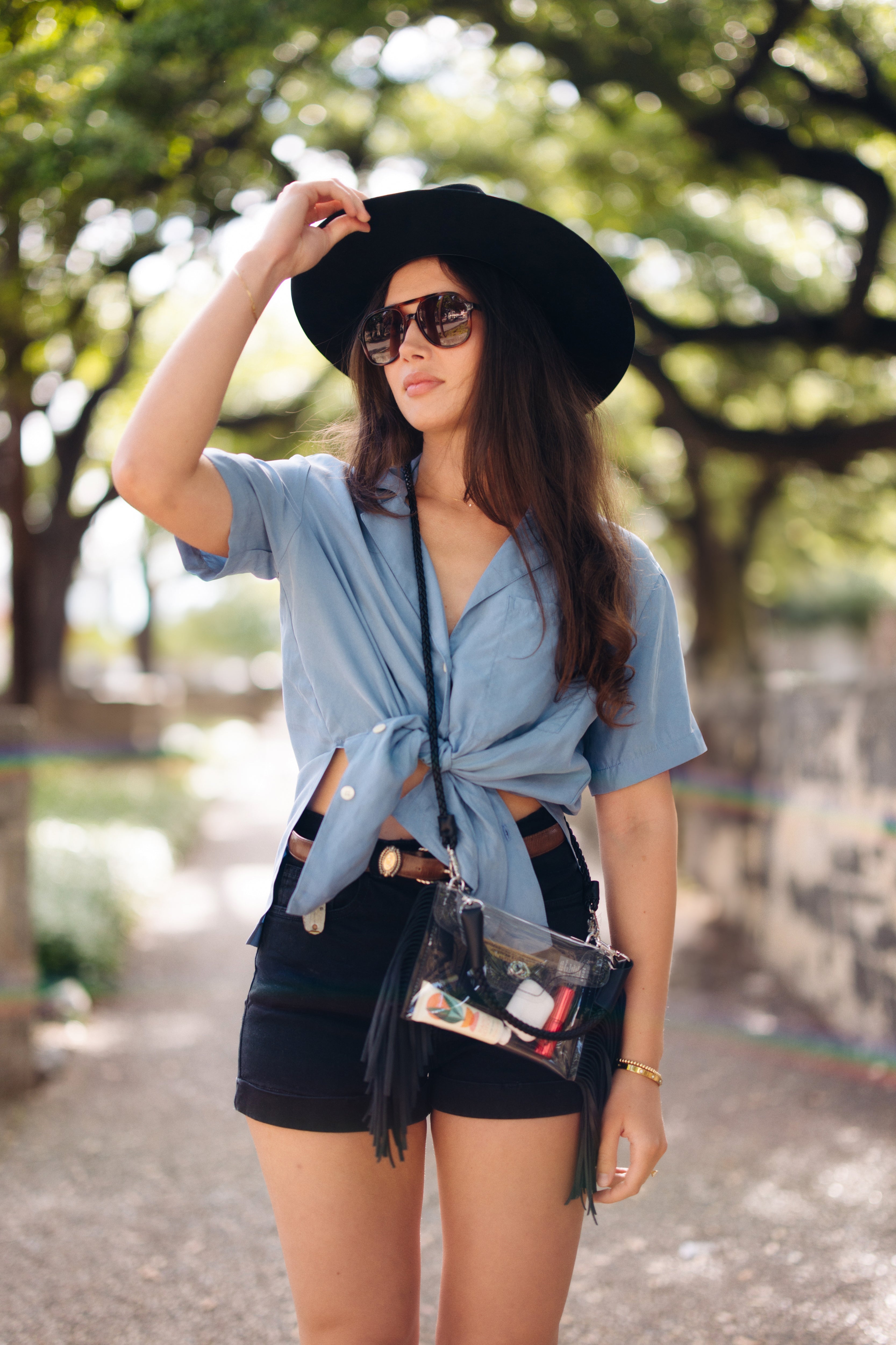 Clear fringe crossbody handbag by Margo Paige with transparent body and decorative fringe detail.