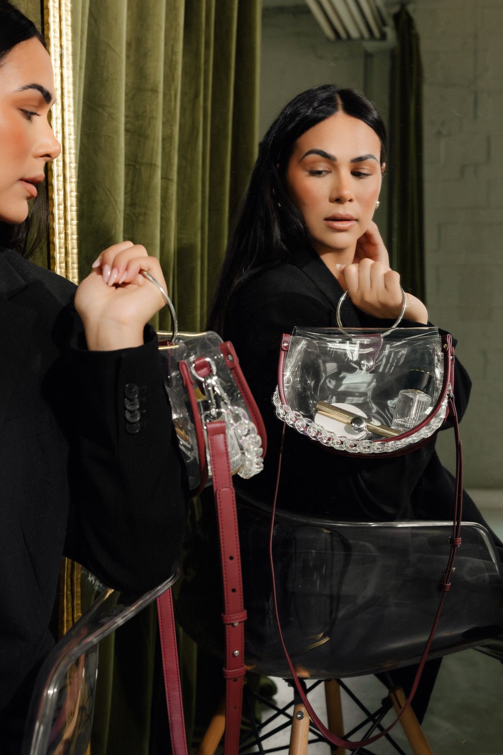 Clear semi-circle crossbody handbag by Margo Paige with a sleek transparent design and adjustable strap.