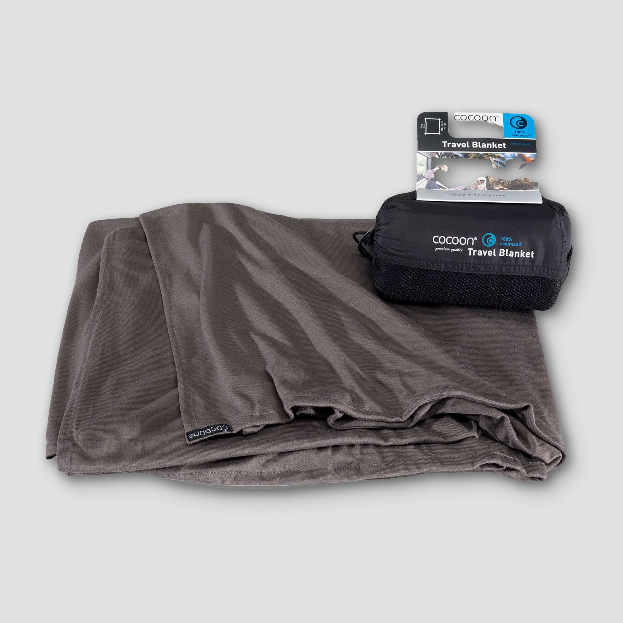 Cocoon COOLMAX® travel blanket in a soft fabric, ideal for camping or travel, showcasing its lightweight design and portability.