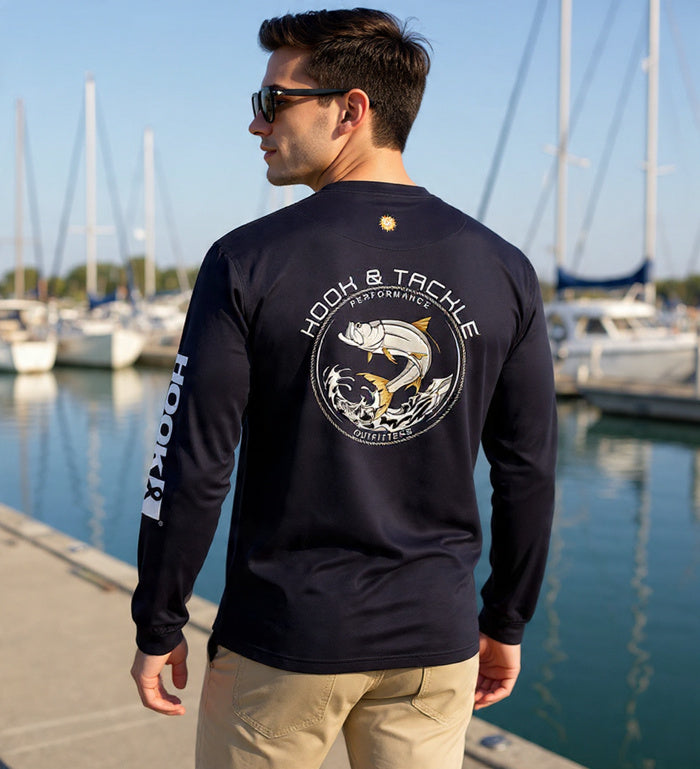 Young man wearing Hook & Tackle Men's Tarpon Leap Thrust L/S UV Fishing T-Shirt outdoors, showcasing UV protection features.