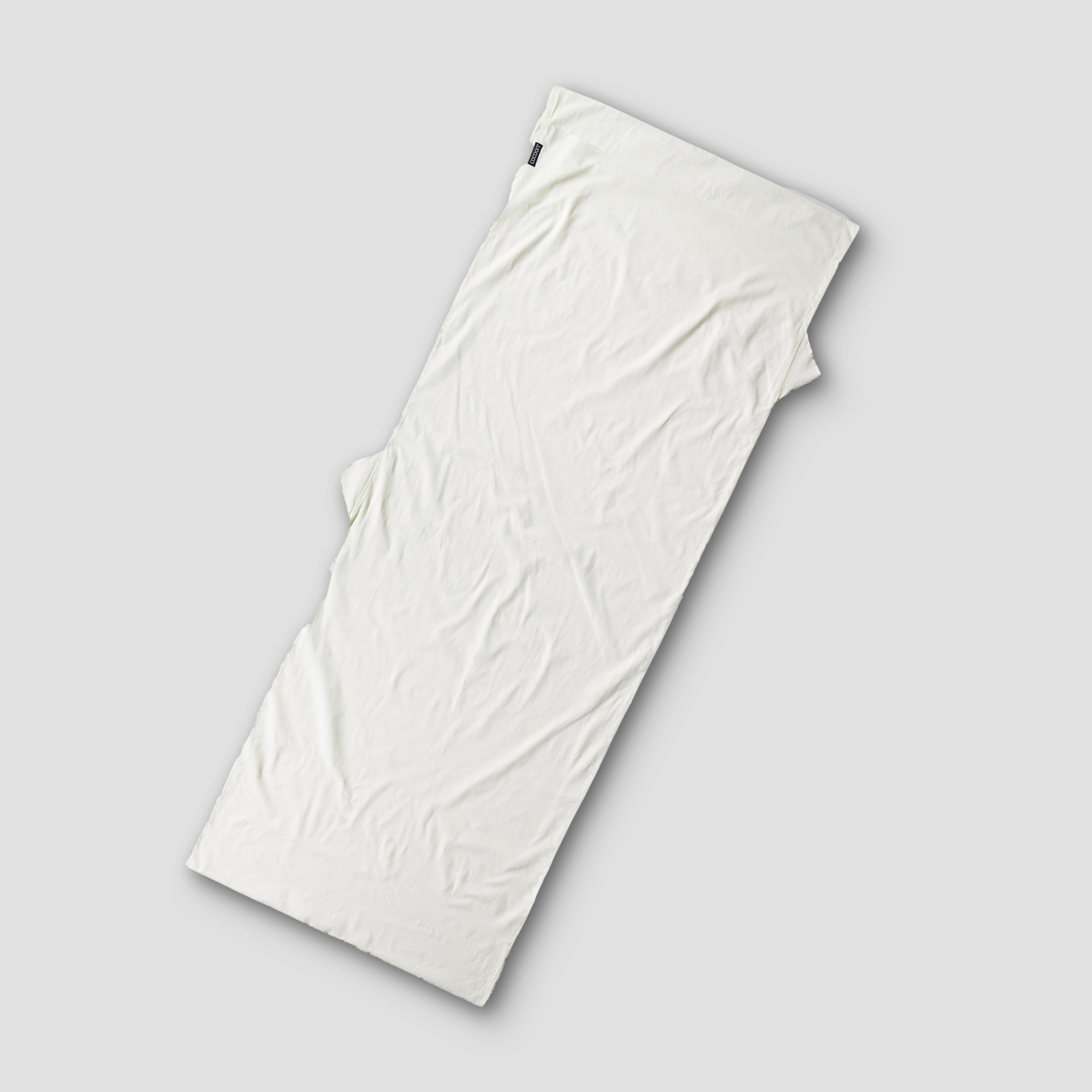 Cocoon TravelSheet™ Cotton XL in white, extra large size, lightweight and breathable for comfortable travel and outdoor use.