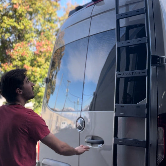 Avatar Offroad Sprinter Van Rear Ladder attached to the back of a custom van, durable steel construction for easy roof access.