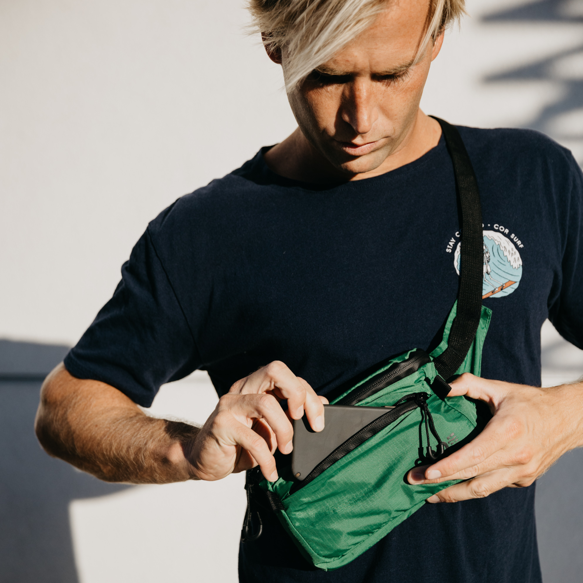 Green COR Surf Daily Cross-Body Hip Pack with 1L capacity, compact waist bag with adjustable strap and multiple compartments.