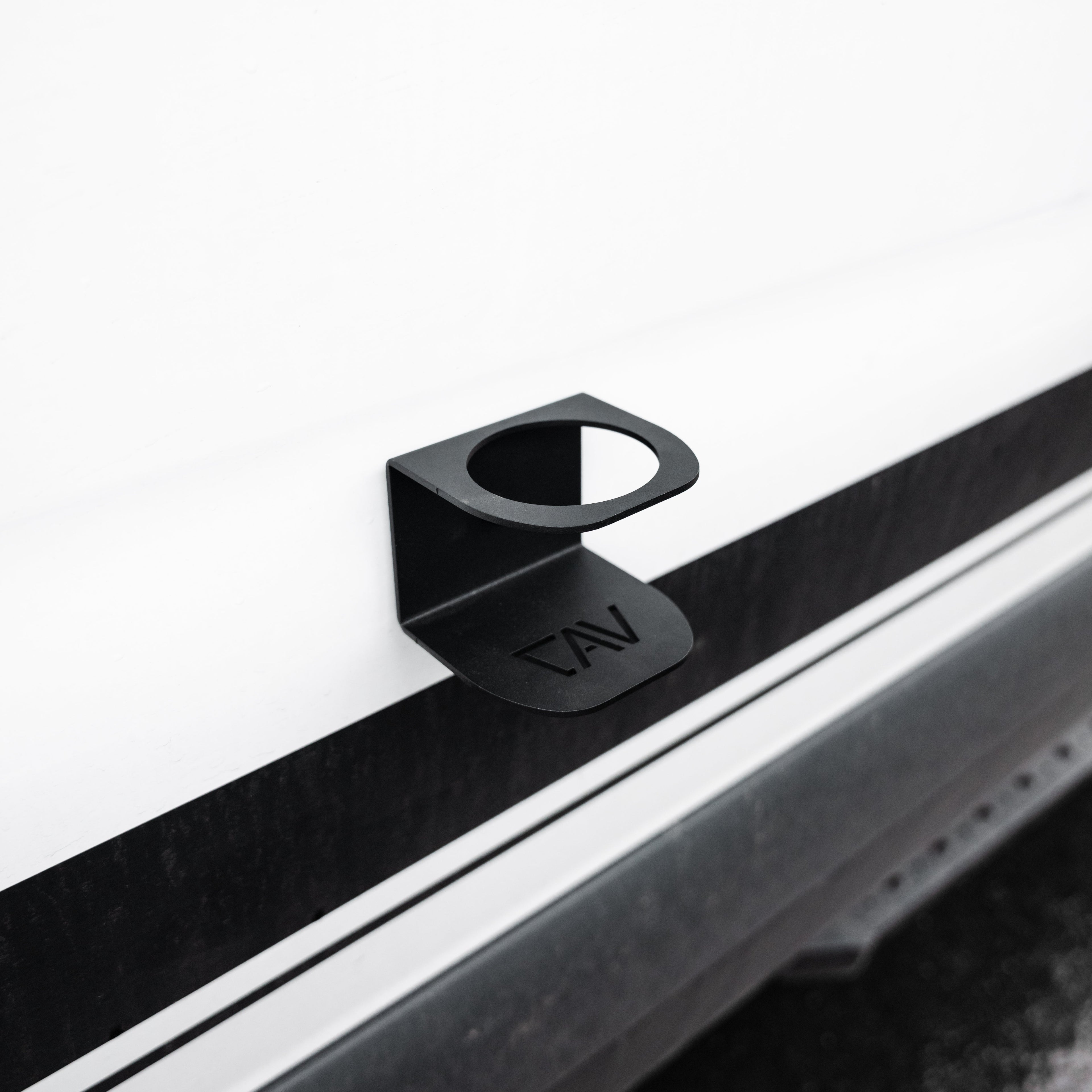 Magnetic Solo Cupholder by Canyon Adventure Vans, made in Utah, shown attached to a vehicle interior for holding a drink.