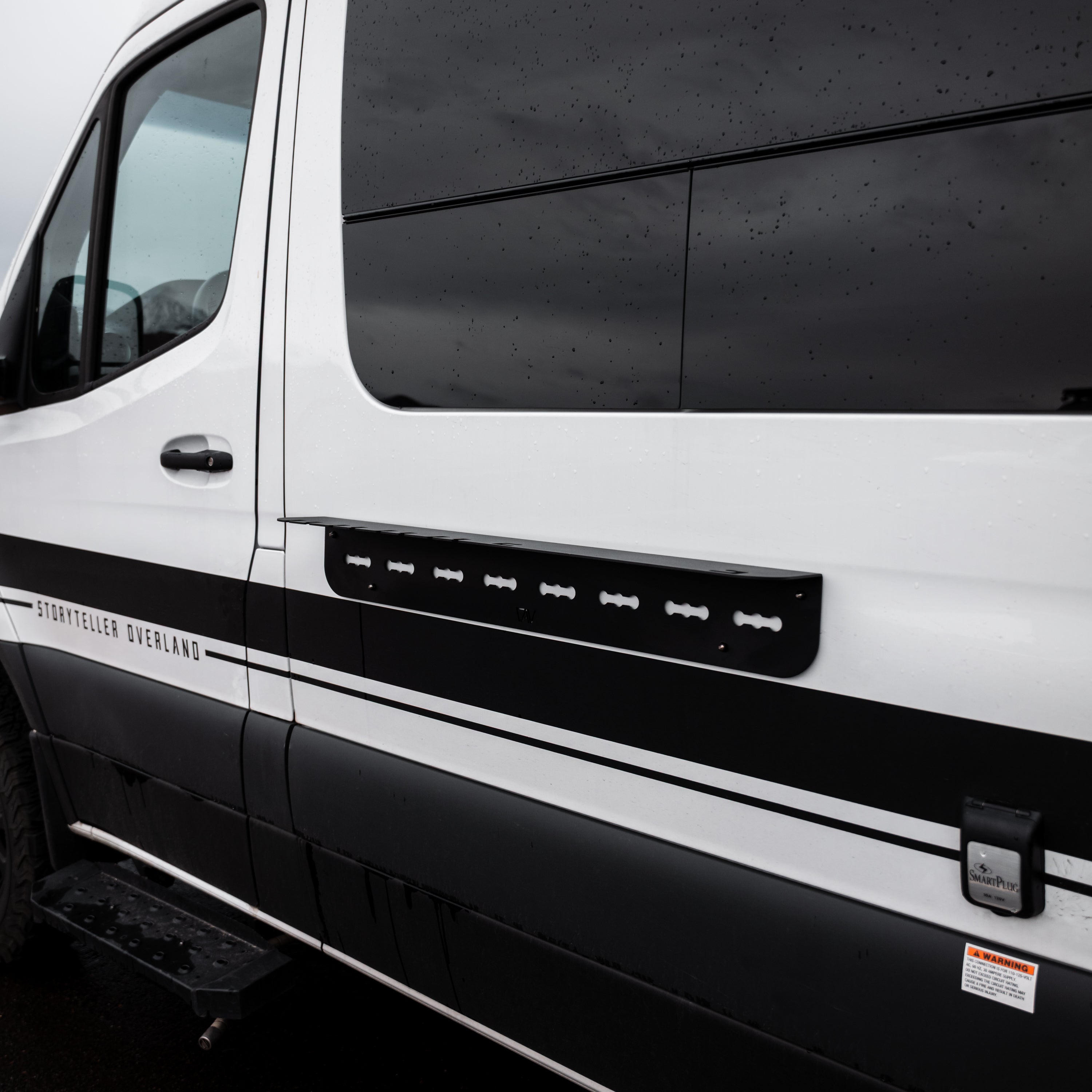 Magnetic outdoor utility shelf by Canyon Adventure Vans, made in Utah, mounted outdoors with securely attached tools and gear.