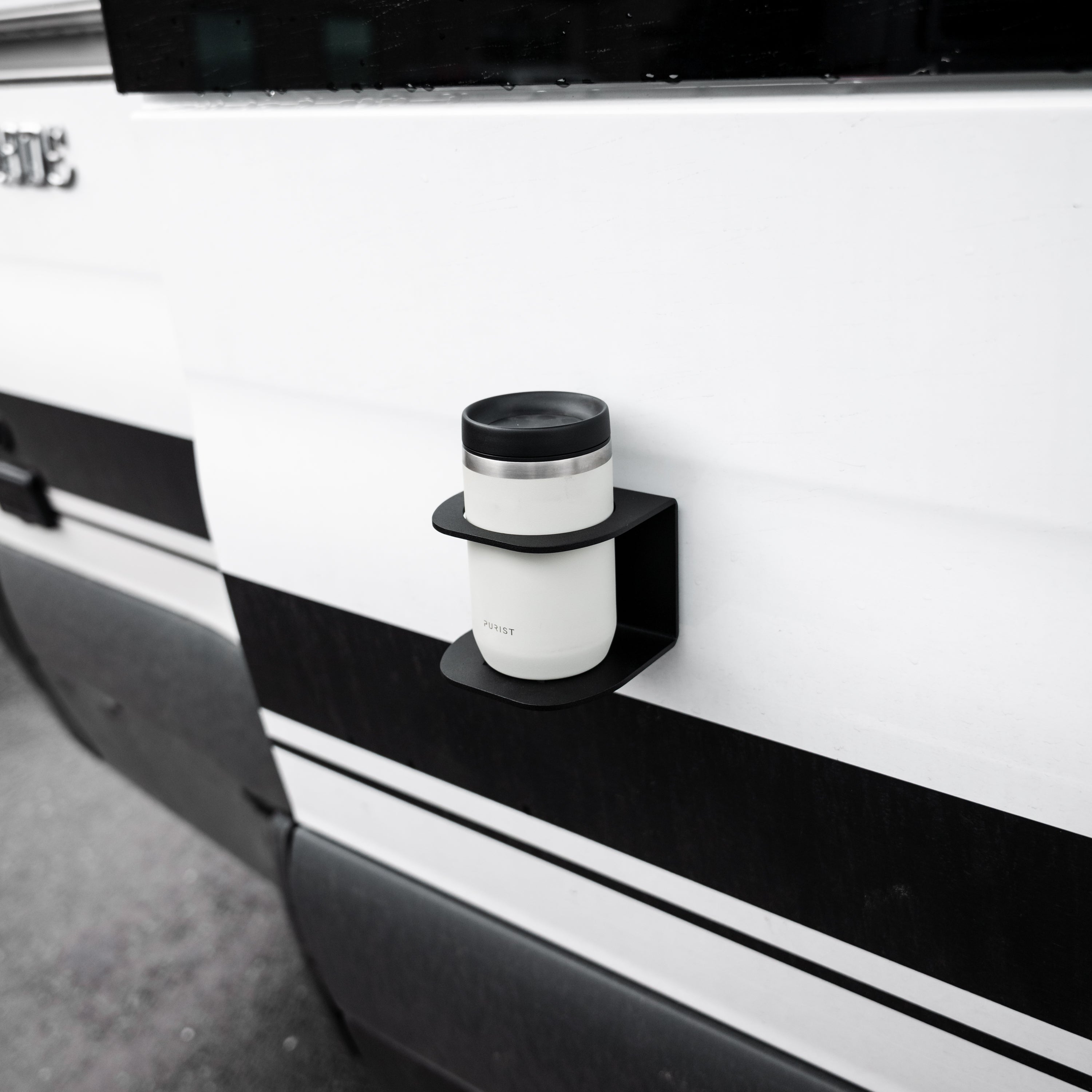 Magnetic Solo Cupholder made in Utah by Canyon Adventure Vans, designed to securely hold a solo cup in a rugged outdoor setting.