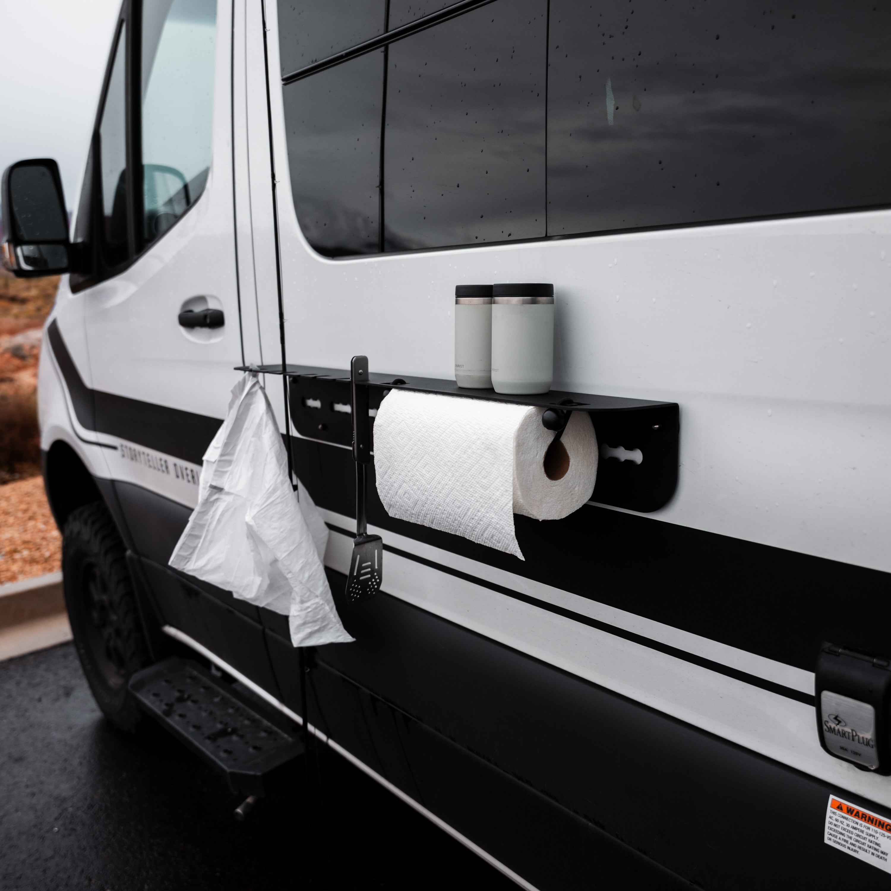Magnetic outdoor utility shelf by Canyon Adventure Vans made in Utah, mounted outdoors with tools and gear stored on the shelf.