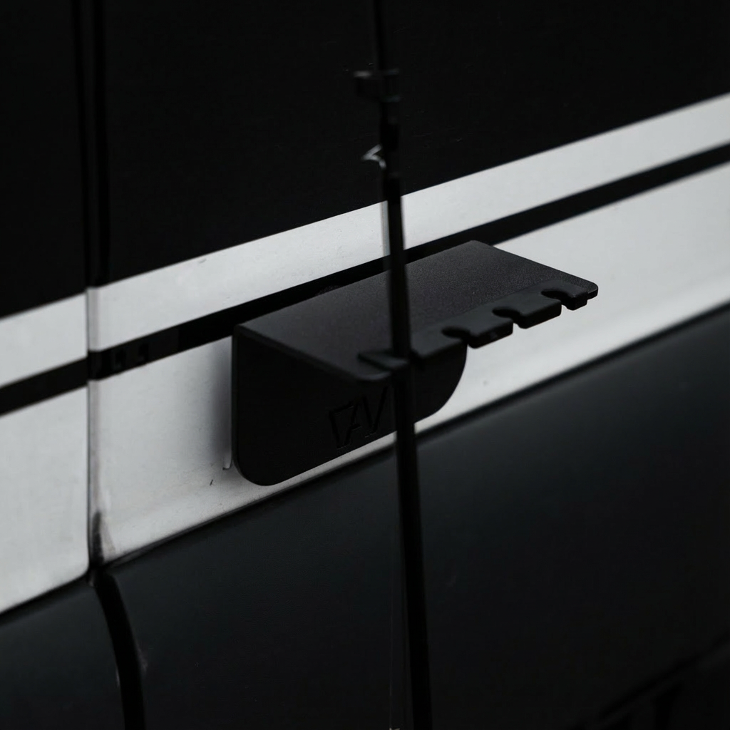 Magnetic fly rod holder by Canyon Adventure Vans, made in Utah, securing a fishing rod on a vehicle or boat.