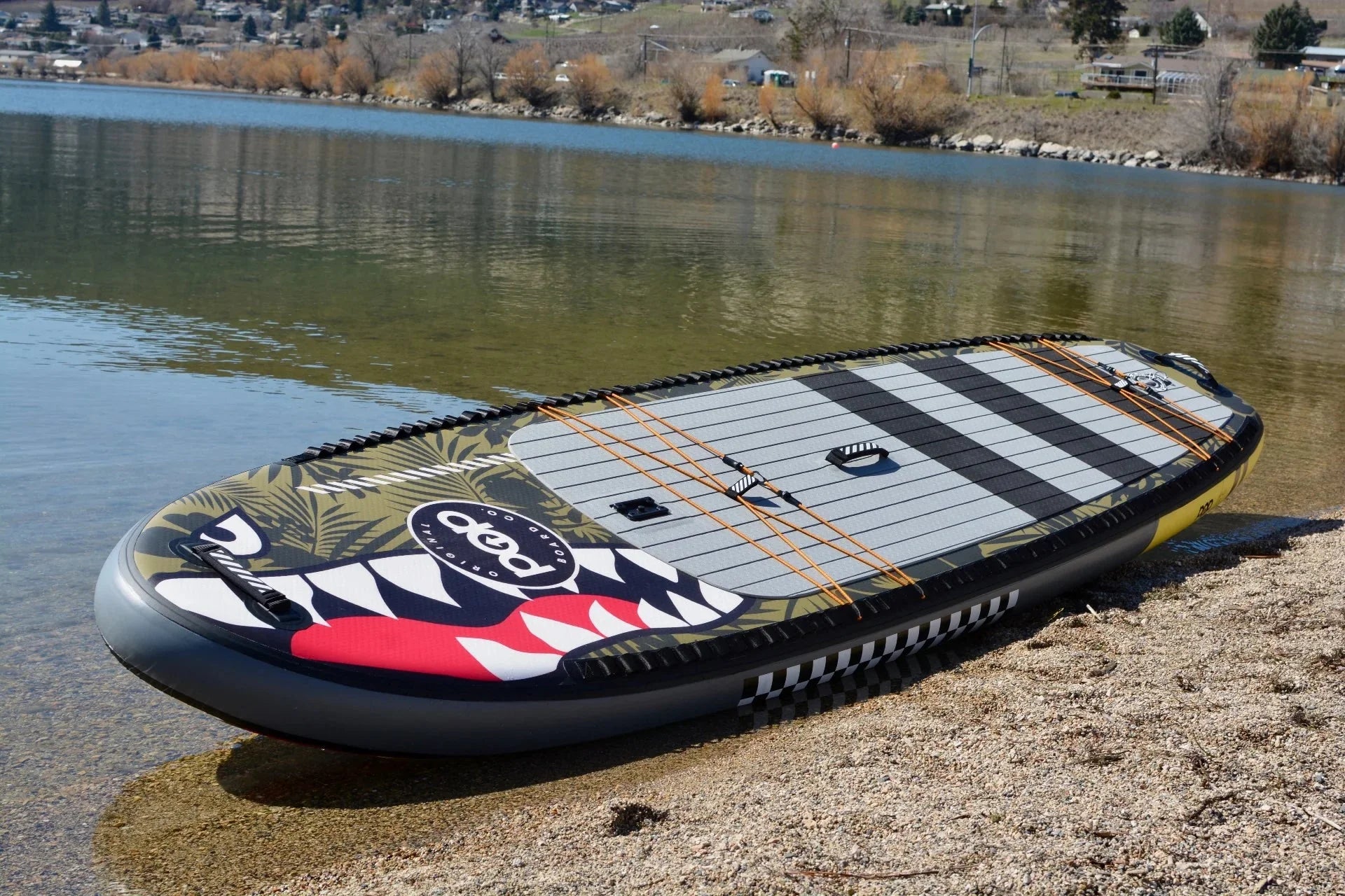 Backcountry Sportsman 11'6 El Capitan Bomber kayak with blue hull and seating, ready for outdoor adventure on calm waters.