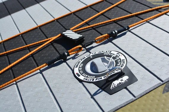 Backcountry Sportsman 11'6 El Capitan Bomber fishing kayak with black and orange design, shown on water with paddle and gear