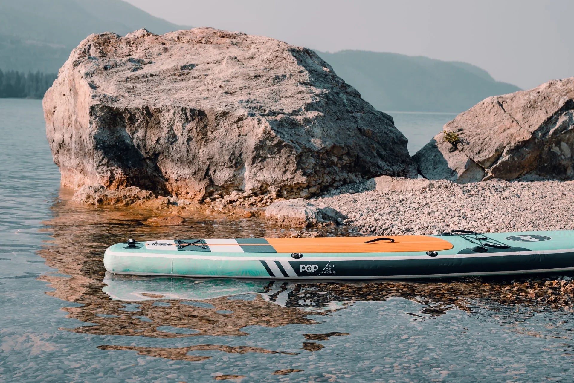Backcountry Sportsman 11'0" Yacht Hopper paddleboard in mint, teak, and blue with a sleek design and textured surface.