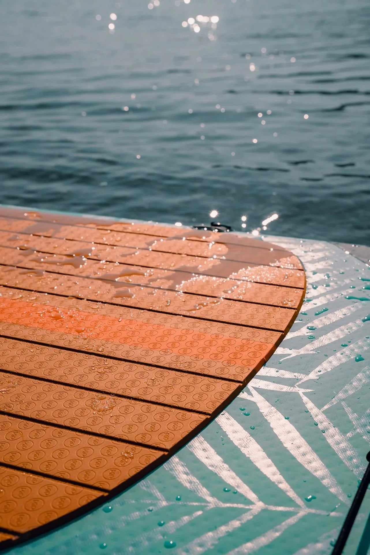 Backcountry Sportsman 11'0 Yacht Hopper paddleboard in mint, teak, and blue with a sleek design and textured surface.
