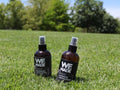 Spray bottle of WE Made Stinky Dog Spray with a white label and blue cap, designed to neutralize pet odors on dogs.