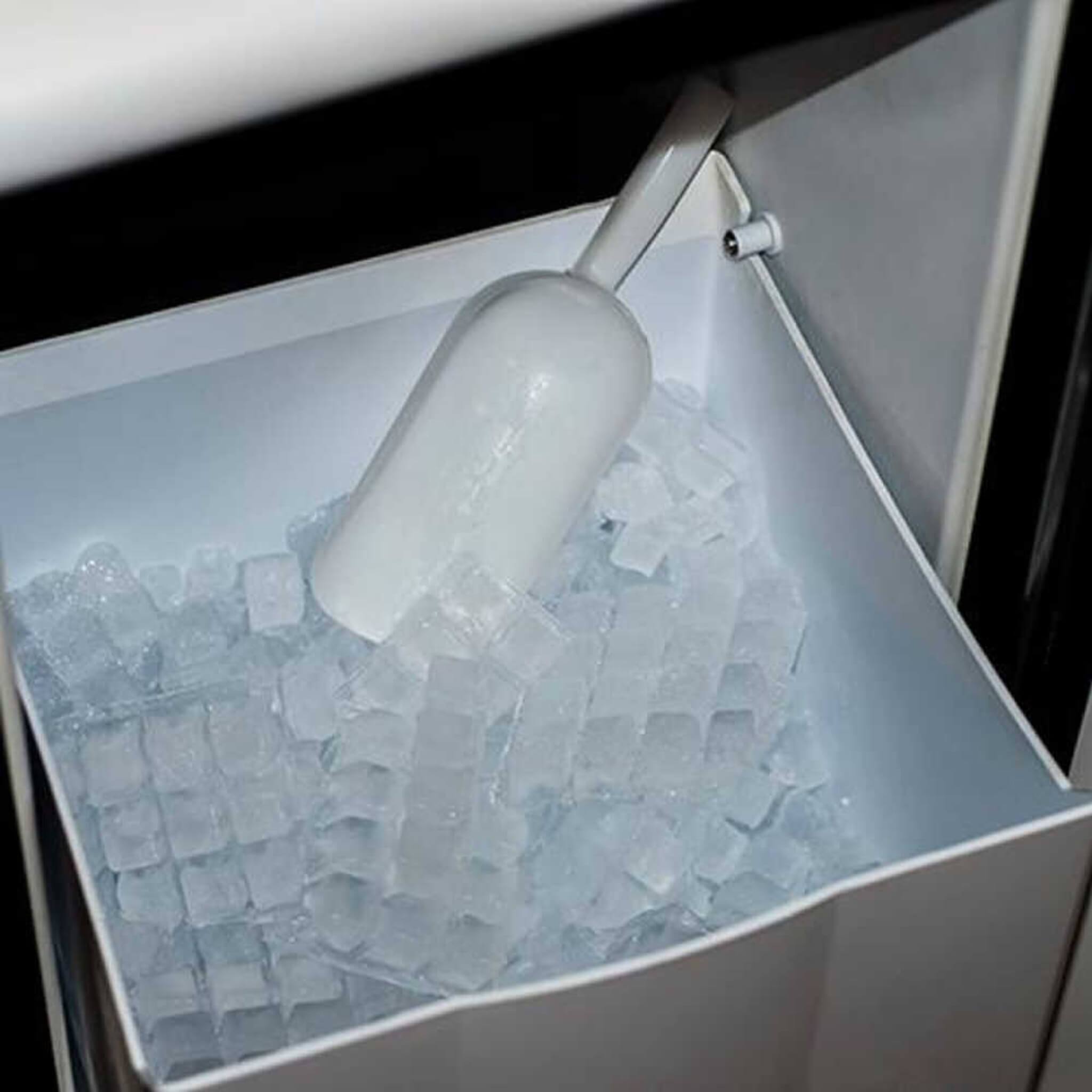 Edgestar 15-inch outdoor undercounter ice maker with ice scoop, producing 50 lbs of ice daily, sleek stainless steel design.