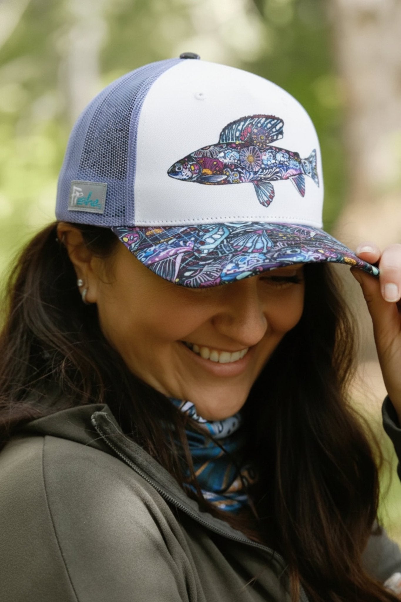 Enchanted Grayling Trucker Hat by FisheWear featuring a gray and black mesh design with an embroidered fish logo.