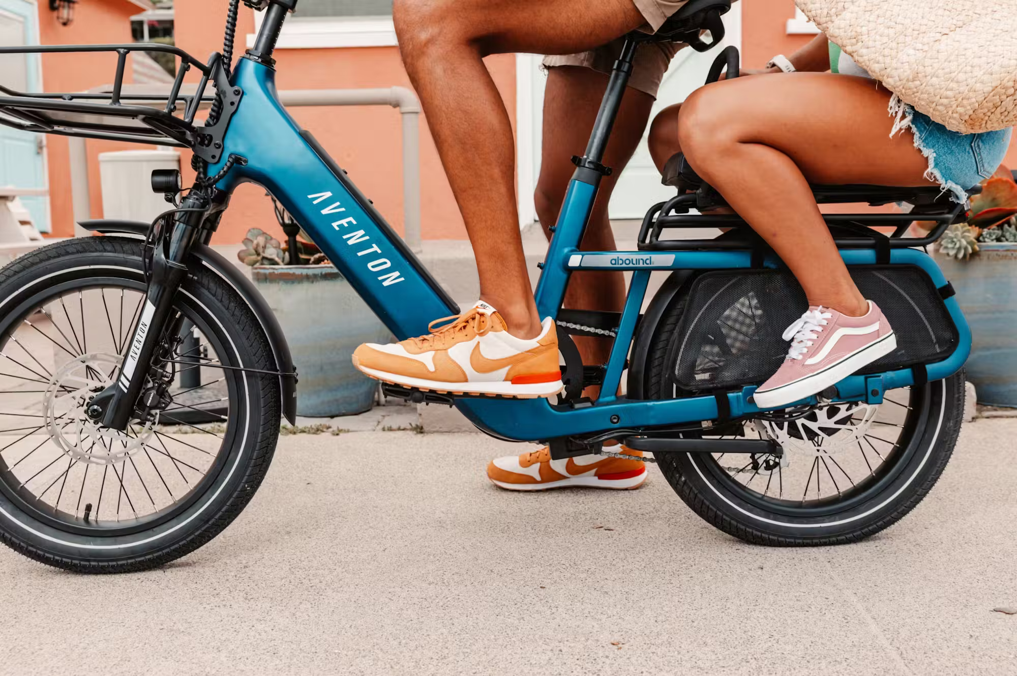 Rex E-Bikes Aventon Abound SR Cargo E-Bike with front cargo rack, black frame, and electric motor for urban commuting and hauling.