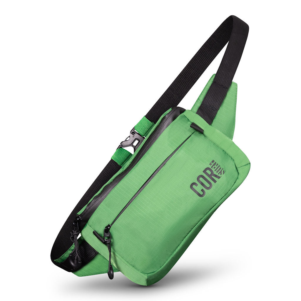 Green COR Surf Daily Cross-Body hip pack with adjustable waist belt, compact 1L fanny pack for outdoor and casual use.