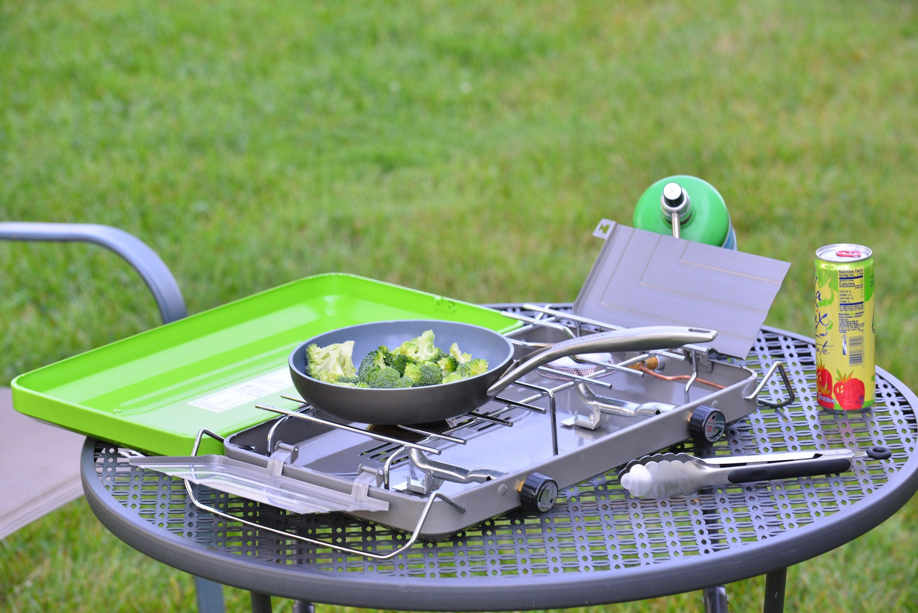 Flame King 2 burner portable propane gas camping stove grill with adjustable burners and sturdy legs for outdoor cooking.