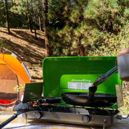 Flame King 2 burner portable propane gas camping stove grill with stainless steel body and adjustable burners outdoors.