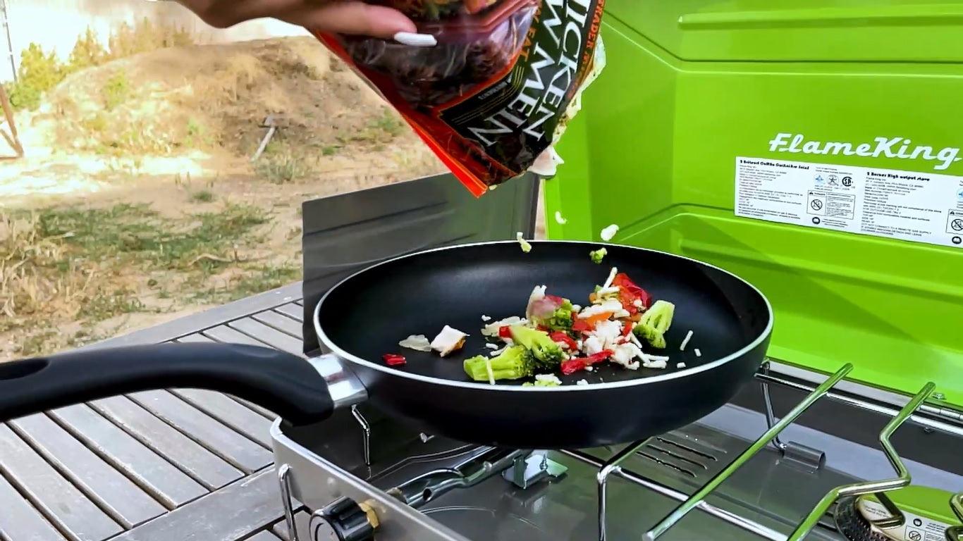 Flame King portable propane gas camping stove grill with two burners, designed for outdoor cooking.