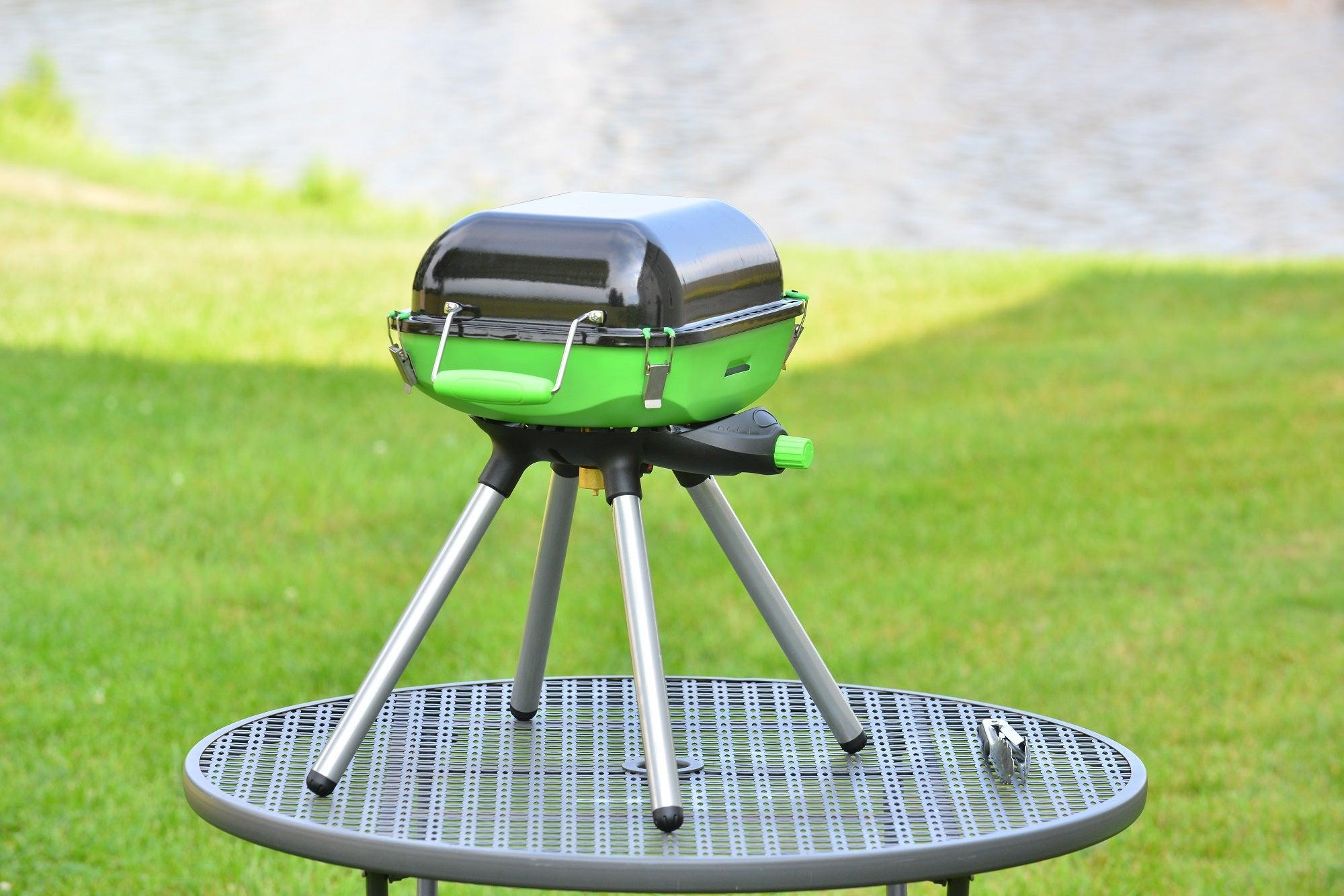 Portable Flame King camping BBQ grill and stove with foldable design, ideal for outdoor cooking and camping activities.