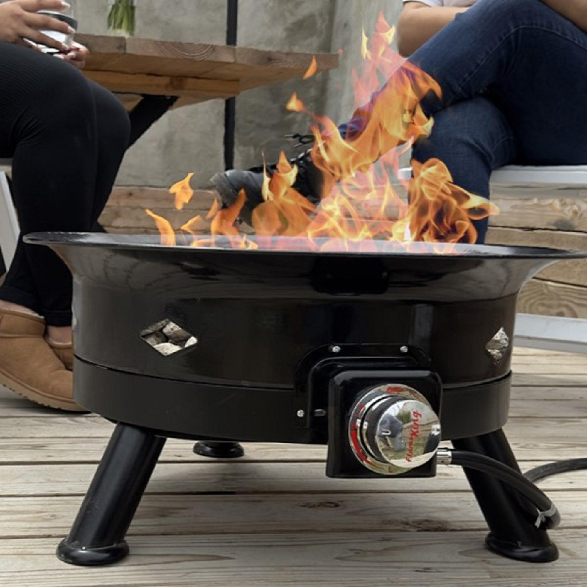 Flame King portable propane fire pit bowl with self-igniter, cover, and carry straps for outdoor home and garden use.