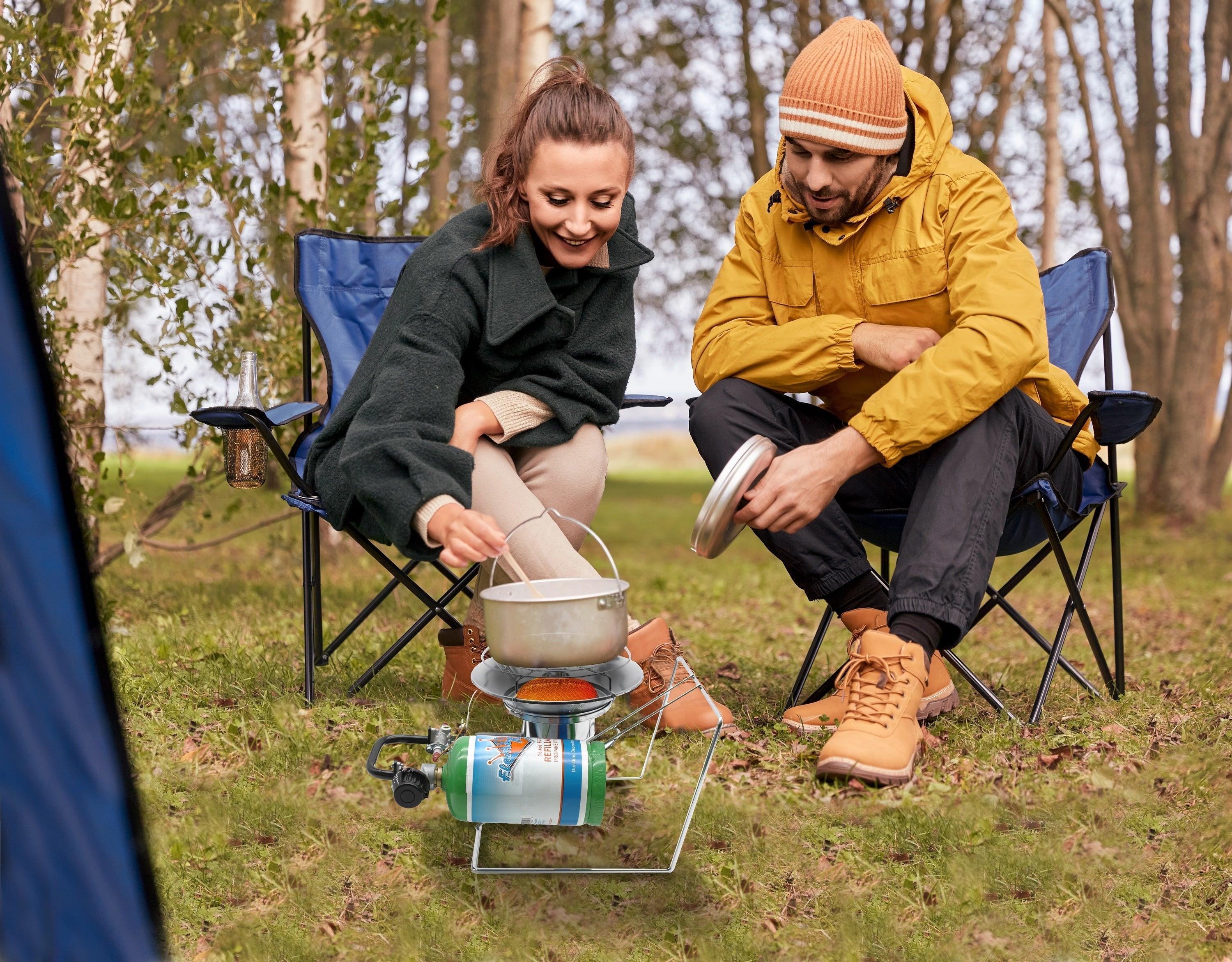 Portable Flame King burner and heater for camping, with multiple uses and sturdy design for outdoor cooking and heating.