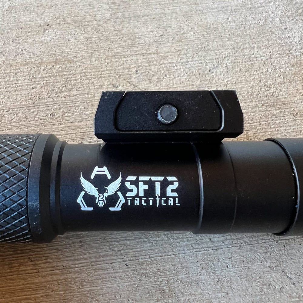 SFT2 Tactical RM19 Tac-Light mounted on a tactical device, showcasing its bright beam and durable design.