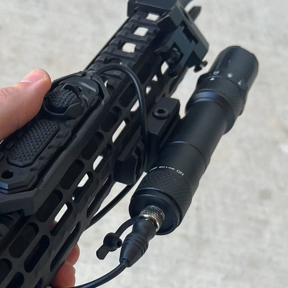 SFT2 Tactical RM19 Tac-Light weapon light laser mounted on a firearm for tactical illumination and targeting.