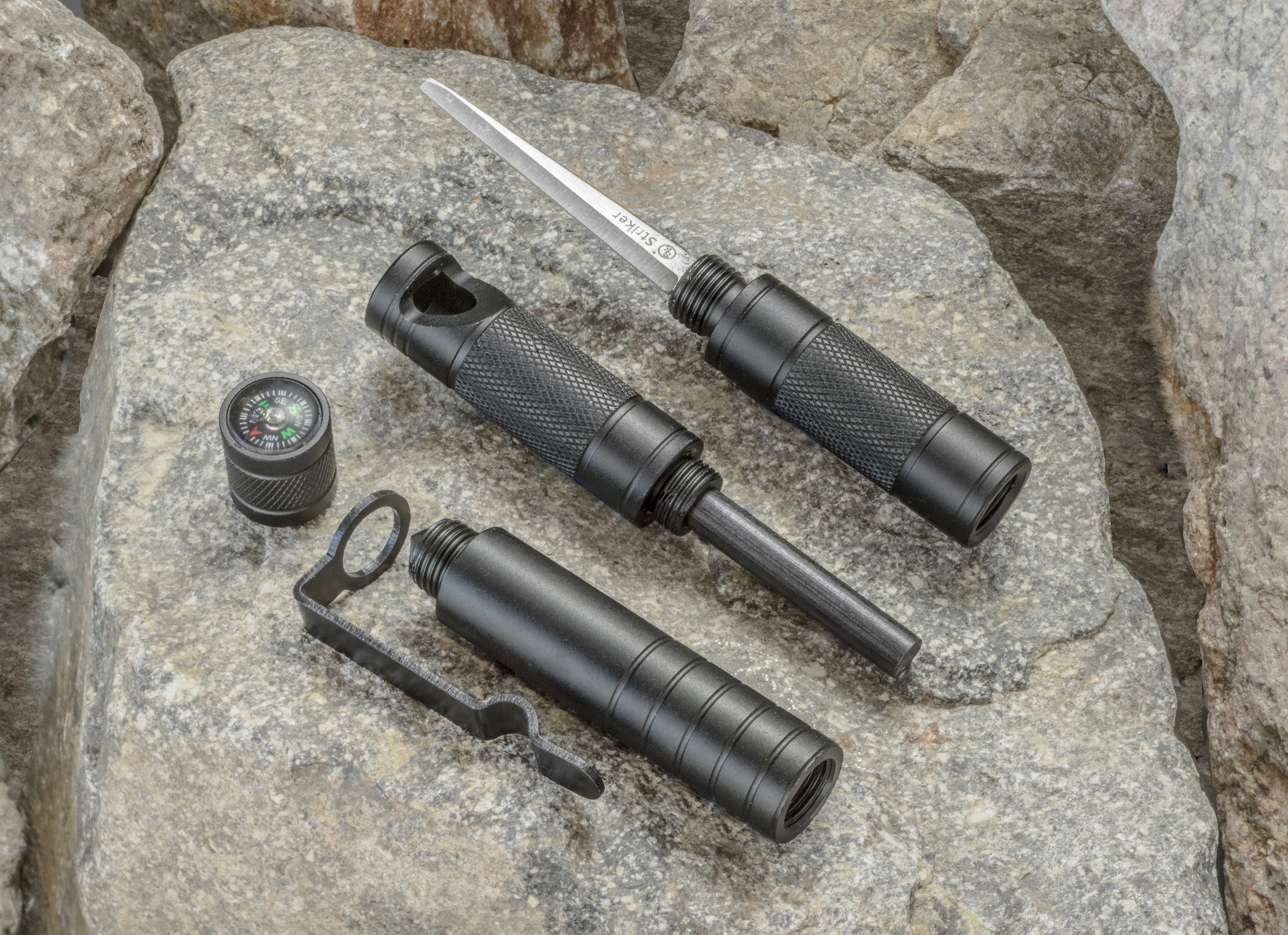Compact 5-in-1 survival tool with flint starter and compass, tactical pen design, by quakekits.com, ideal for outdoor emergencies.