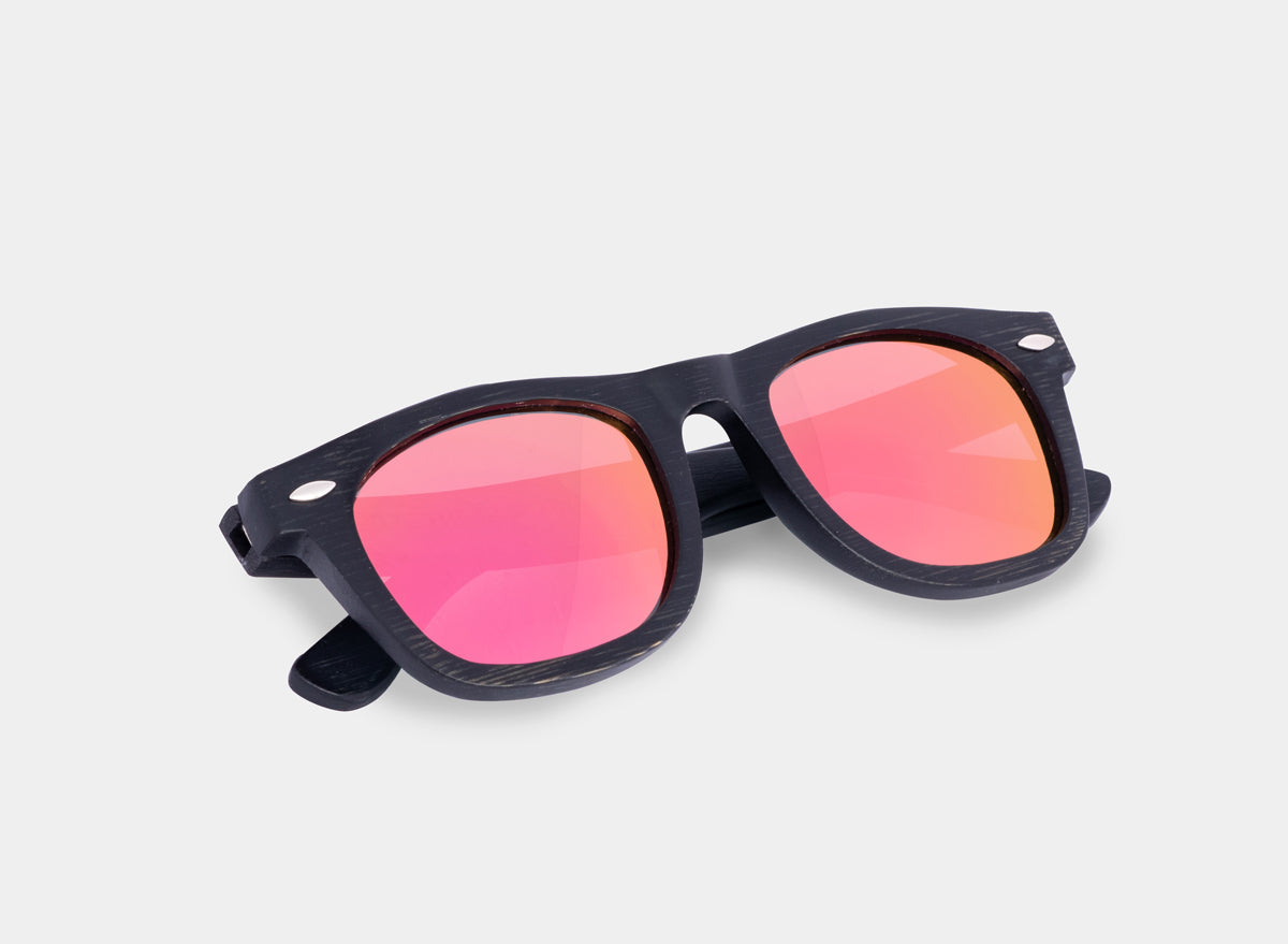 Black and pink bamboo floating sunglasses by Eastern Outer with lightweight frames and polarized lenses.