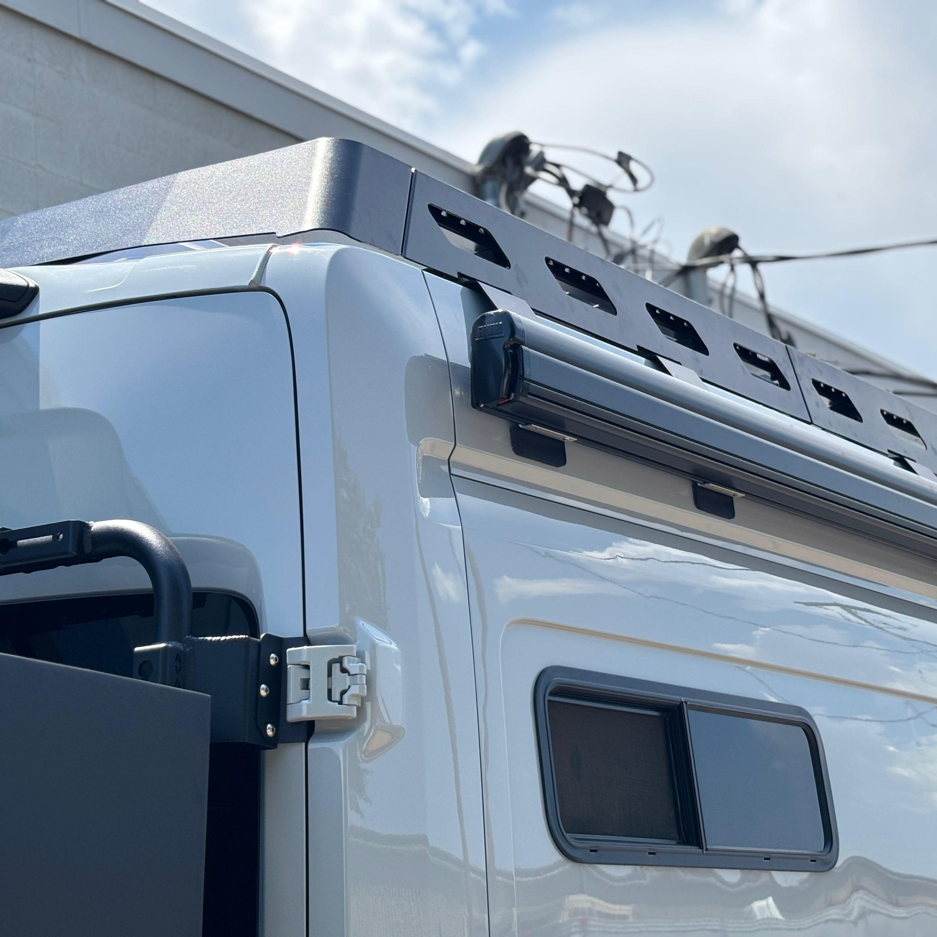 Ford Transit van with Avatar Offroad Pioneer Transit Roof Rack installed for added cargo space and roof storage.