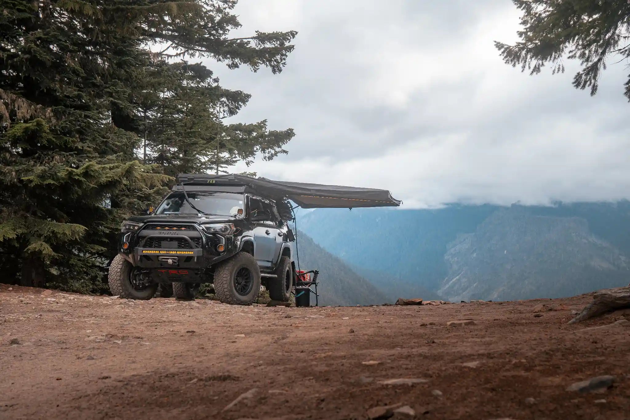 Freespirit Recreation 180 Awning installed on a Toyota 4Runner, showcasing durable fabric and sturdy mounting setup.