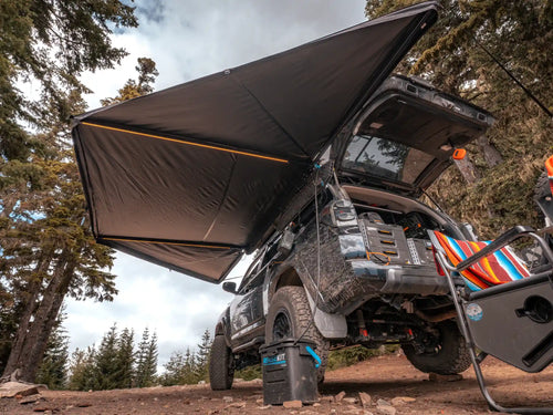 Freespirit Recreation 180 Awning V2 installed on a vehicle with integrated LED lights for shade and outdoor comfort.