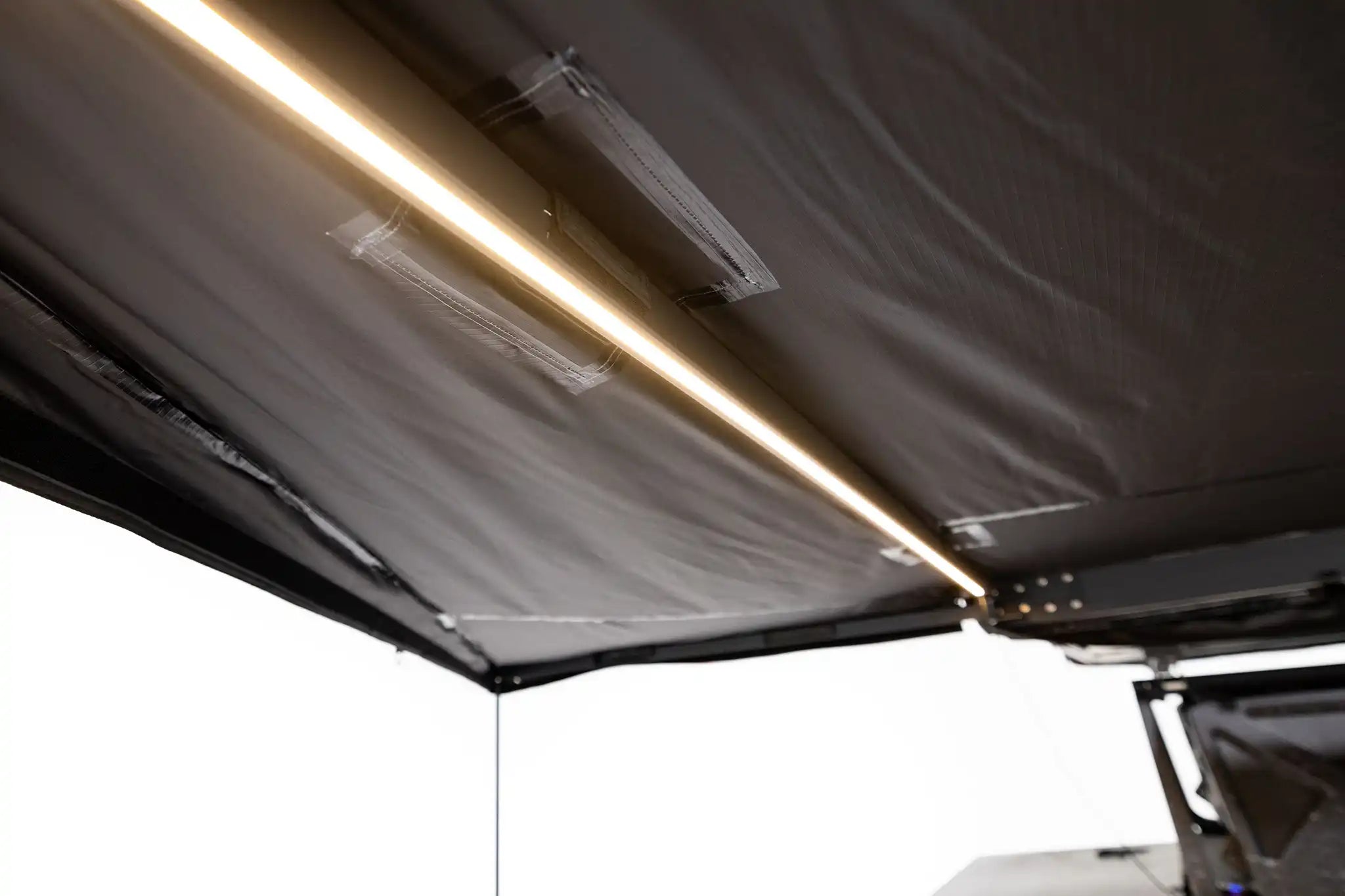 Freespirit Recreation 180 Awning V2 with integrated lights, outdoor camping accessory providing shade and shelter under the awning.