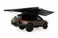 Freespirit Recreation 180 Awning V2 extended over a vehicle, showcasing its spacious canopy and sturdy support structure.