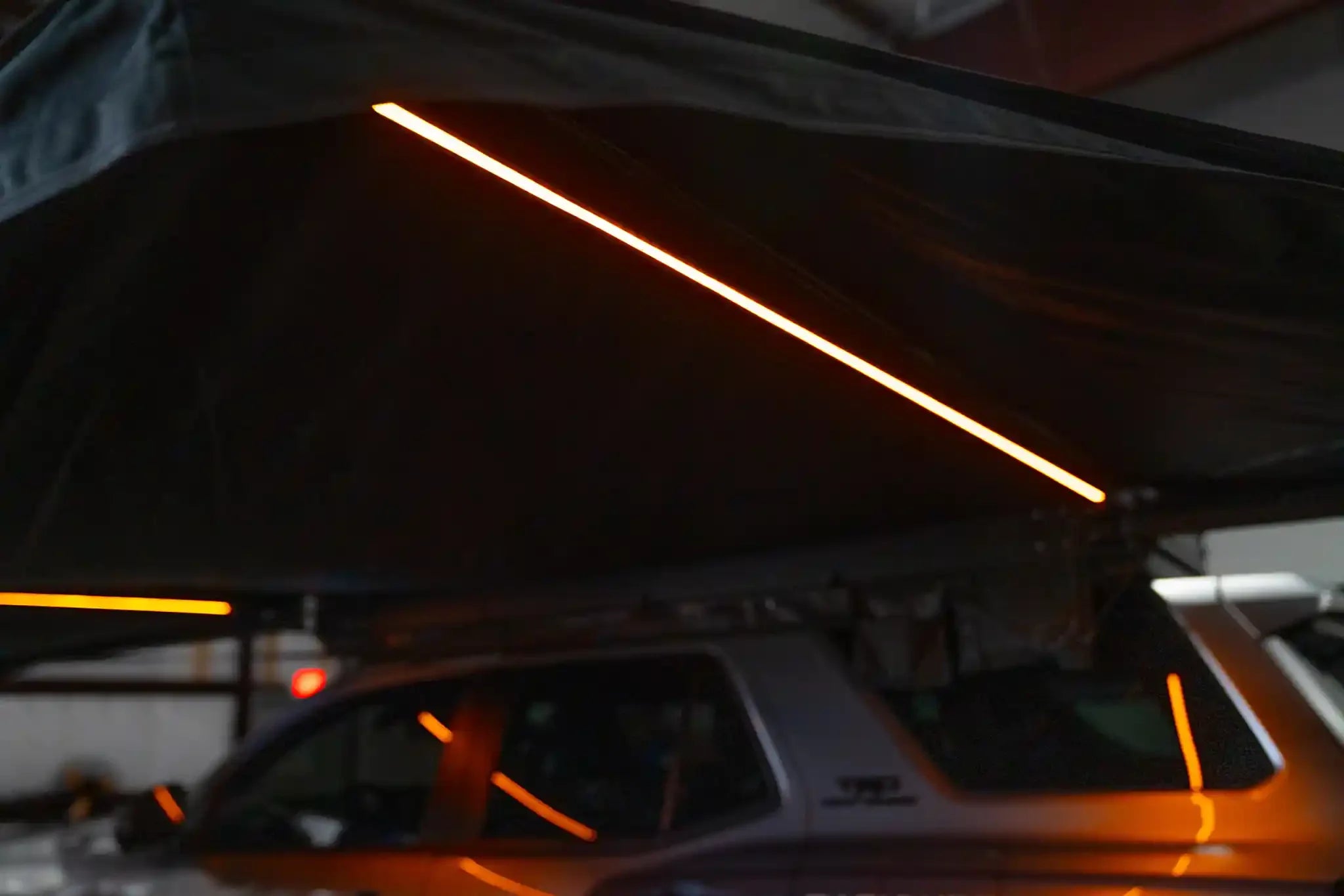 Freespirit Recreation 270 Awning V2 with amber LED lights, fully extended, showcasing durable outdoor awning setup.