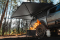 Freespirit Recreation 270 Awning V2 setup over a campsite, providing shade and shelter for outdoor activities.