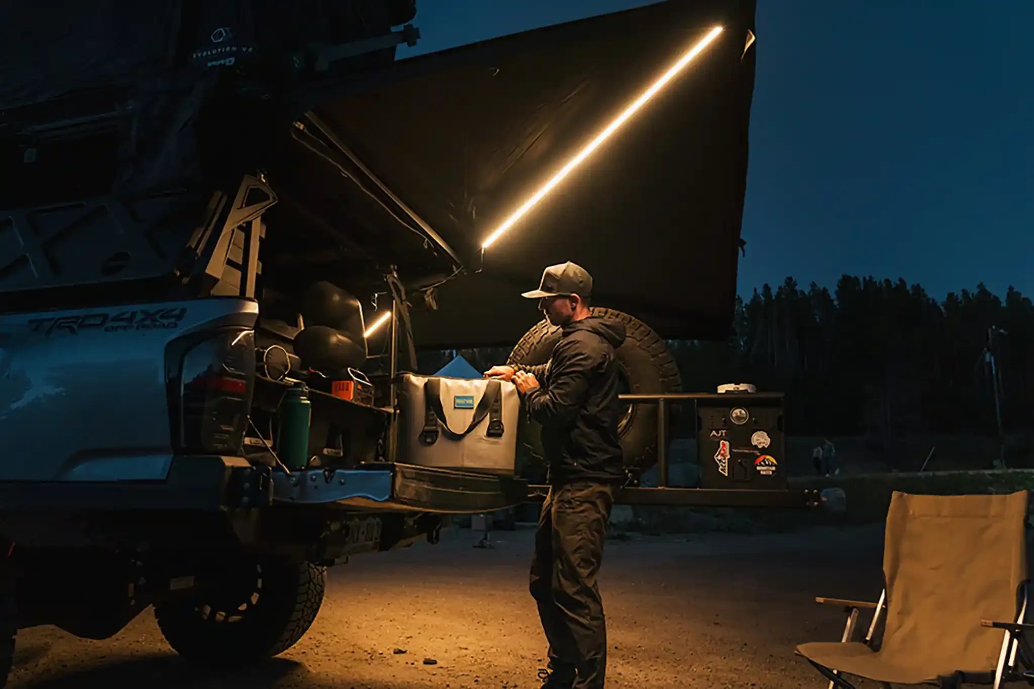 Freespirit Recreation 270 Awning V2 extended on a vehicle, providing shade with durable fabric and adjustable support poles.