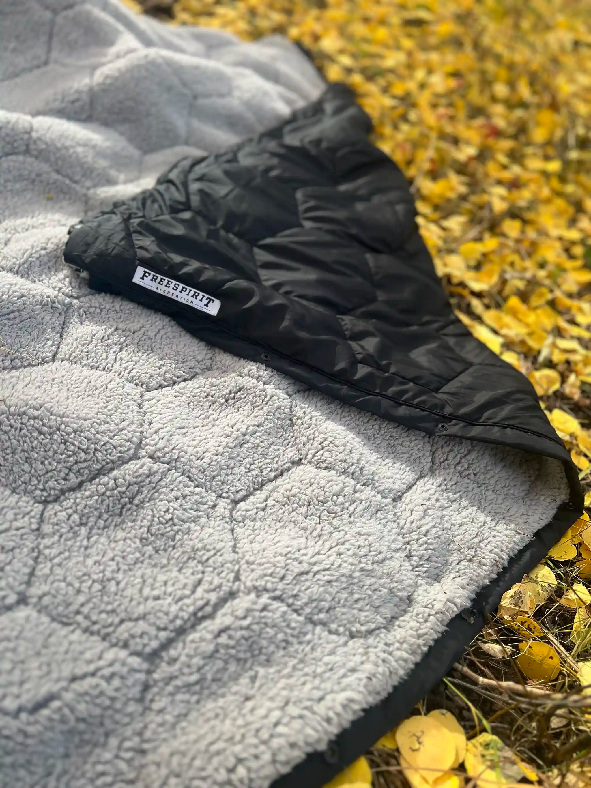 Freespirit Recreation Anywhere Poncho outdoor camping blanket, versatile outerwear for warmth and comfort during outdoor activities.
