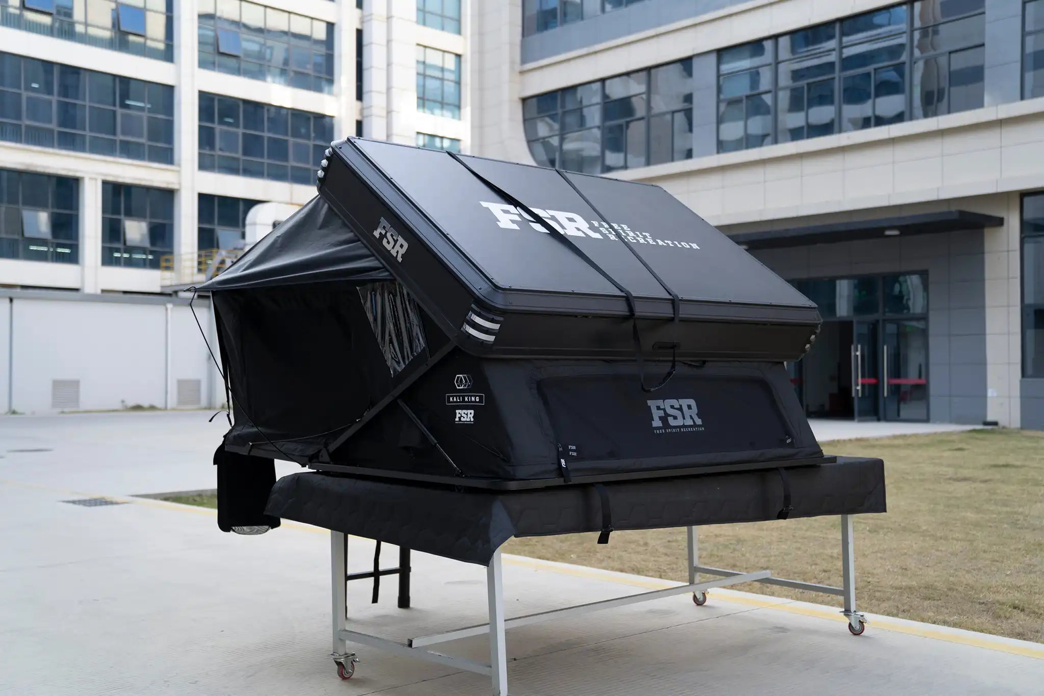 Freespirit Recreation Kali King rooftop tent viewed from the back side, featuring fabric, window openings, and rooftop mount.