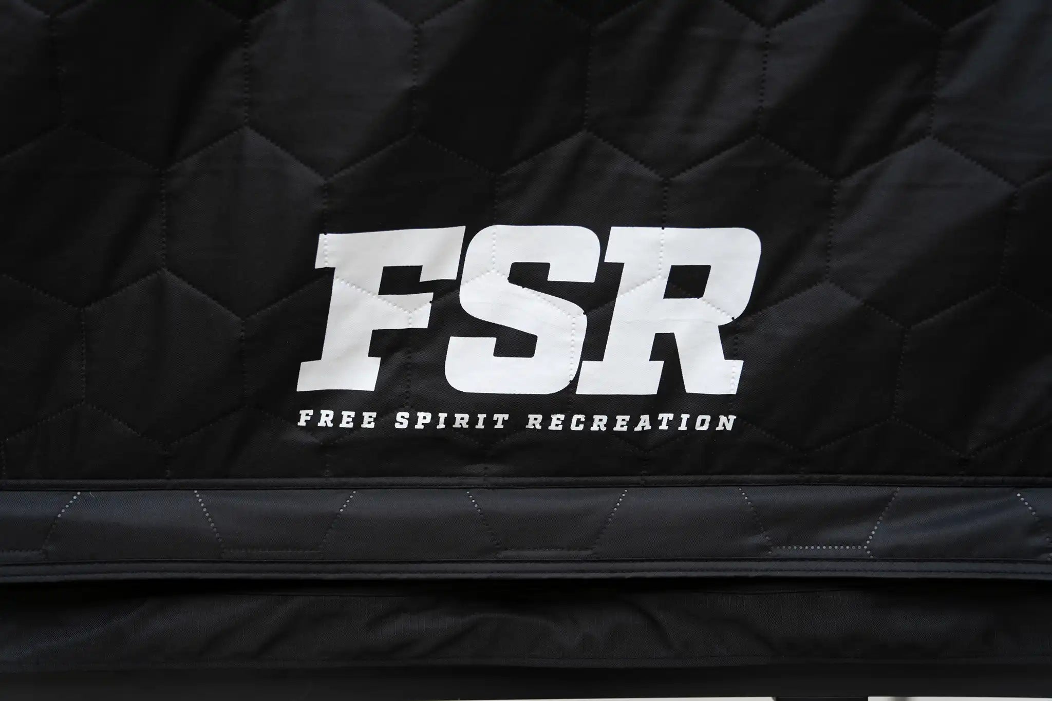 Freespirit Recreation Kali King rooftop tent door with durable fabric and mesh windows for ventilation and protection.