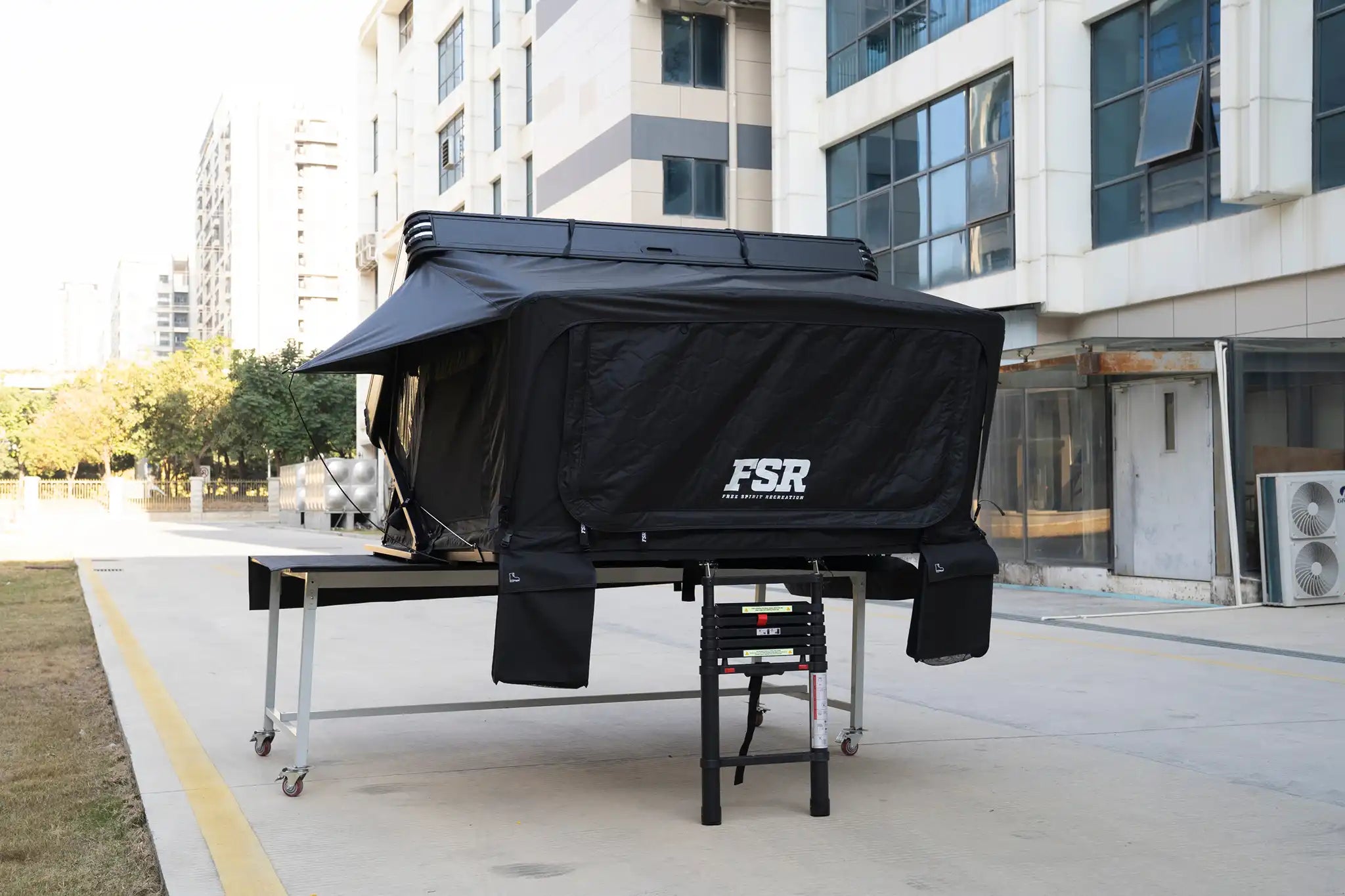 Freespirit Recreation Kali King rooftop tent with closed front door, mounted on vehicle, durable fabric and sturdy frame visible.