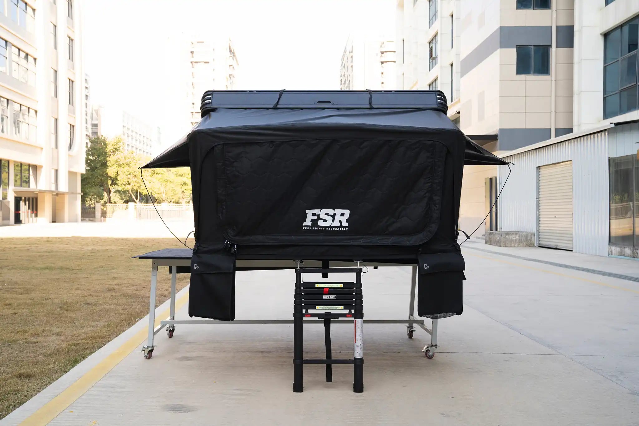 Freespirit Recreation Kali King rooftop tent mounted on a vehicle, open front view showcasing its sturdy design and camping setup.